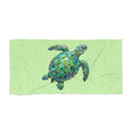 Beach towel printed with a colorful painterly sea turtle in dreamy ocean water
